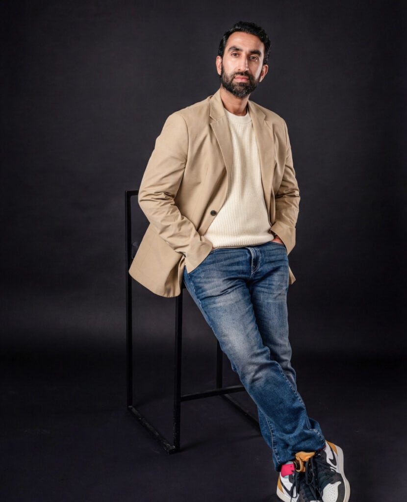 Manick Bhan standing confidently for brand identity.